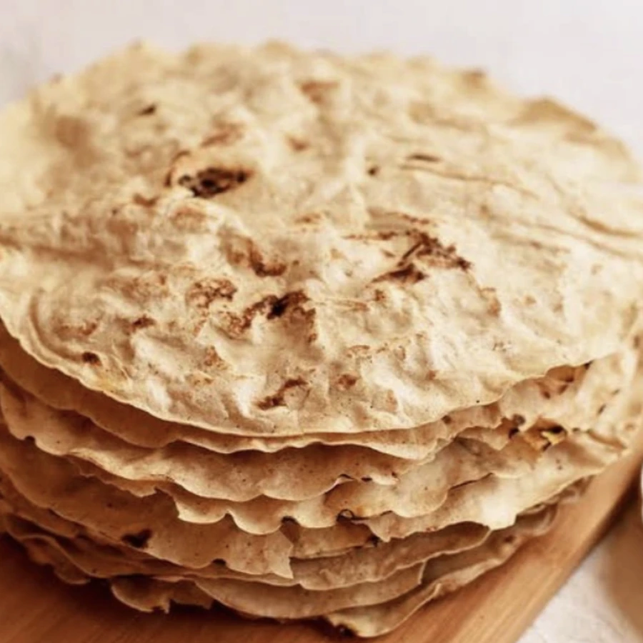 A stack of Henchu jawar gati rotis on a wooden board