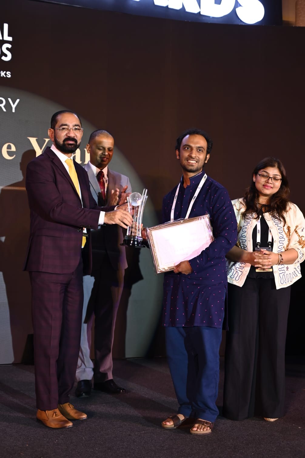 Karthik of Henchu holding the AI Startup of the Year certificate as the trophy is handed over