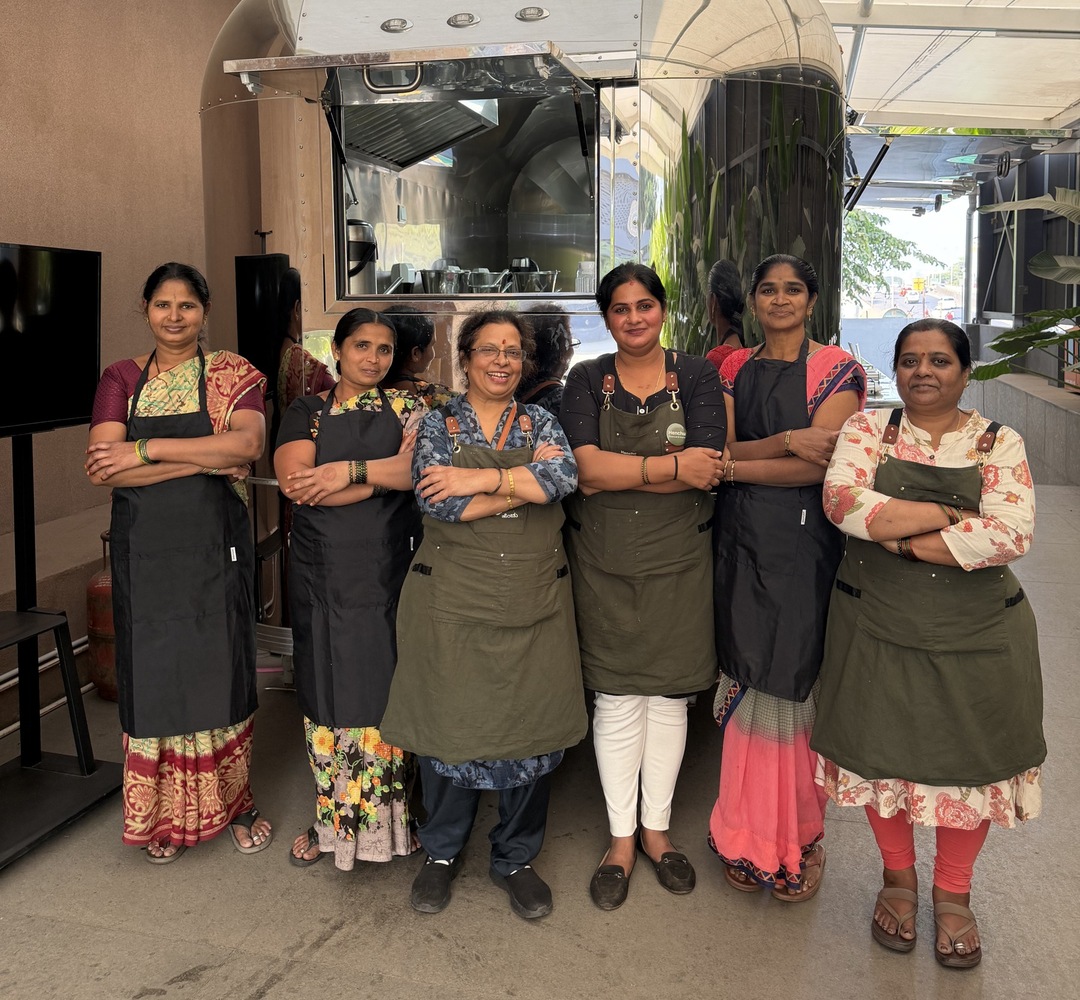 Six of the Henchu mothers in green aprons